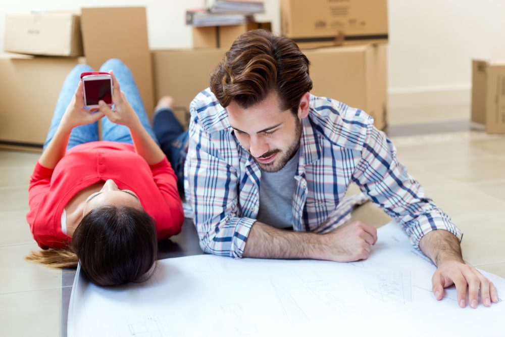 young-couple-looking-blueprints-their-new-home